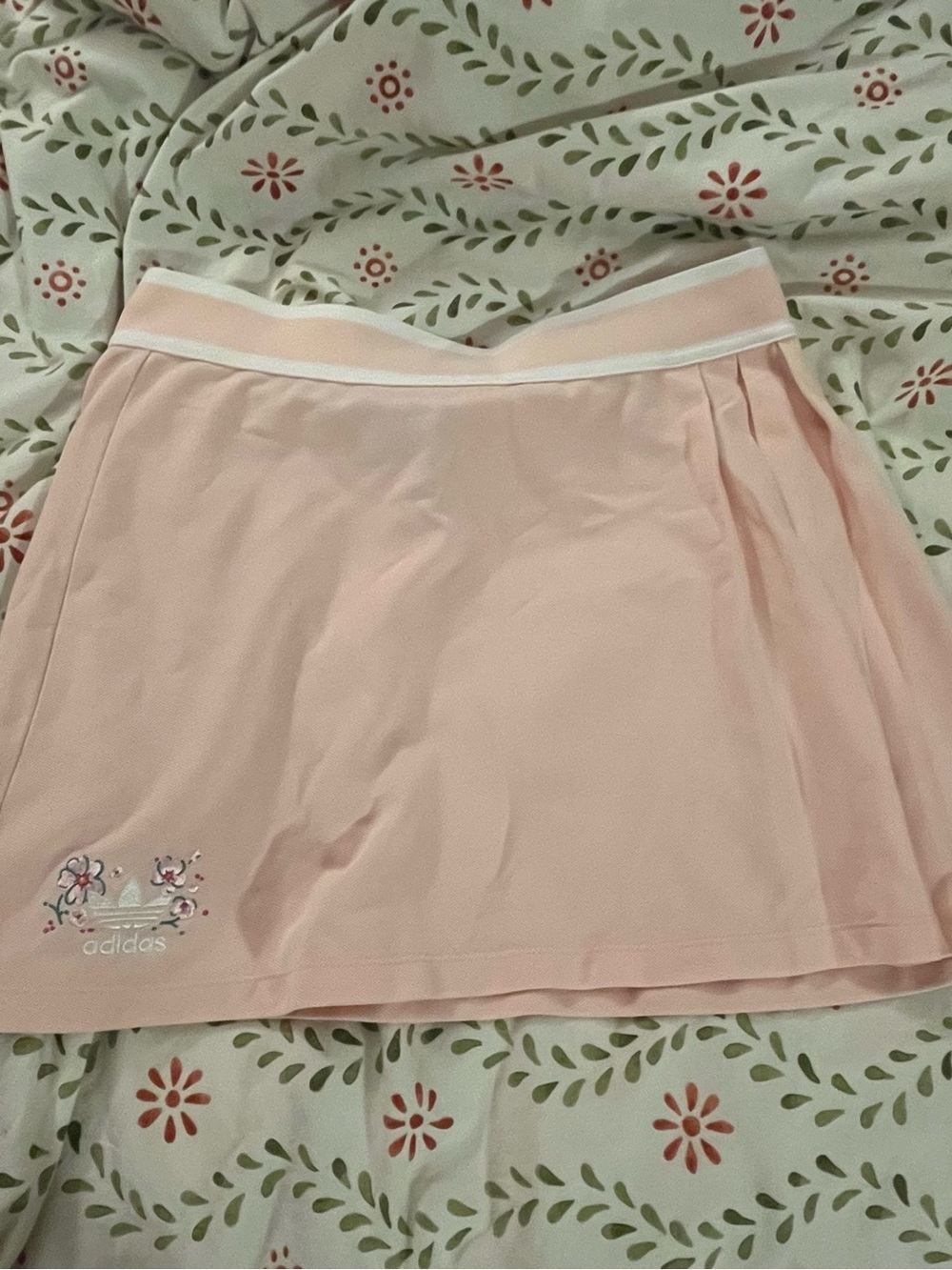 light pink adidas mini tennis skirt with floral embroidery